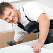 rent a husband: handsome man smiling doing handy work