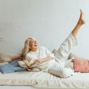 gray haired woman in bed kicking her legs up